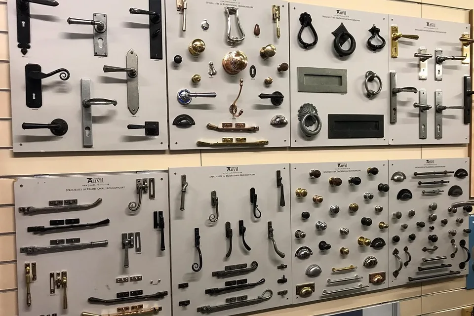 Display boards holding door handles, knobs, hinges and other metal hardware